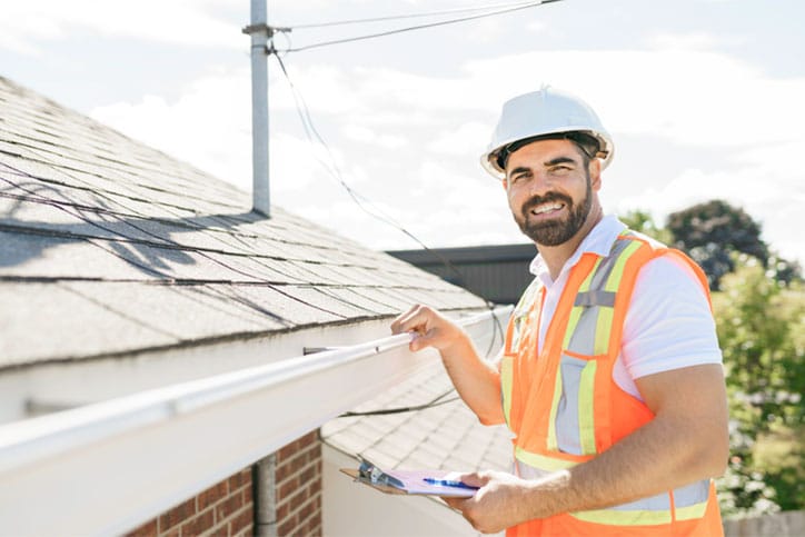 Home Inspector Looking At Gutters